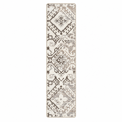 Afterimage area rug: a long rectangular area rug with a distressed geometric and tribal-inspired pattern in beige, cream, and brown tones, shown flat against a solid white background.
