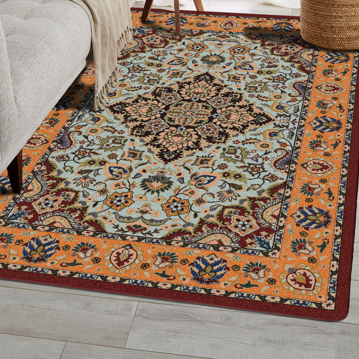 Bright Side orange and blue area rug with persian inspired graphics in modern color palette nylon fibers and pet friendly and kid friendly low voc anti allergen in sitting aea with taupe couch and planket…