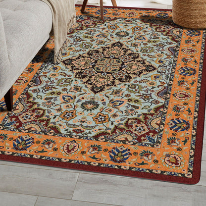 Bright Side orange and blue area rug with persian inspired graphics in modern color palette nylon fibers and pet friendly and kid friendly low voc anti allergen in sitting aea with taupe couch and planket…