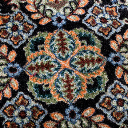 Close up ttexture shot of the Bright Side orange and blue area rug with persian inspired graphics in modern color palette nylon fibers and pet friendly and kid friendly low voc anti allergen.