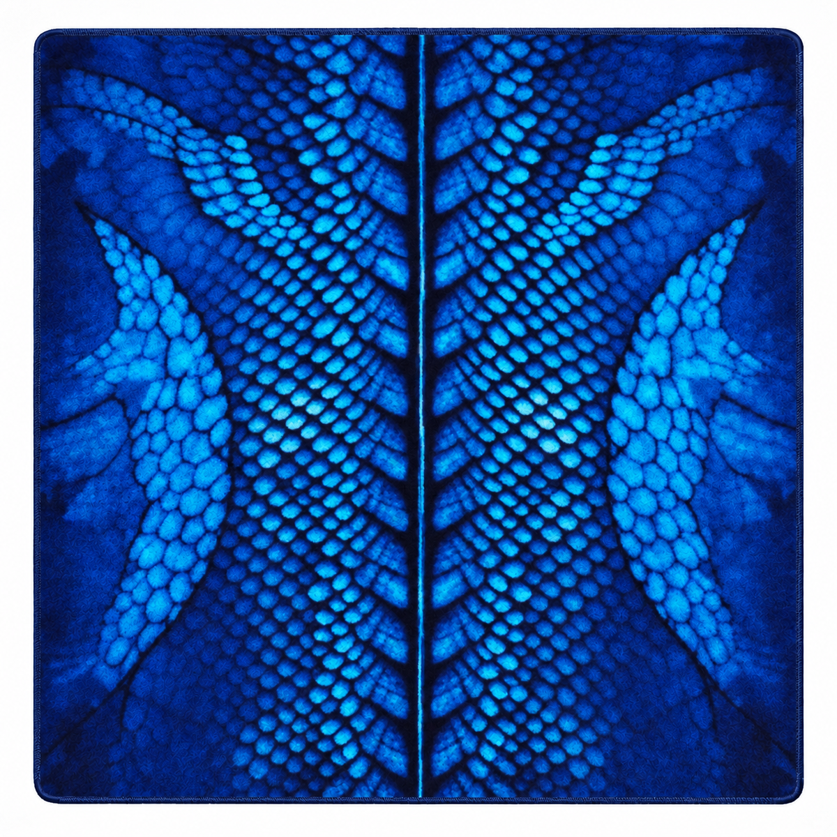 A square blue textile item, likely a pouch or small bag, featuring a symmetrical dragon scale pattern in various shades of blue and dark navy.