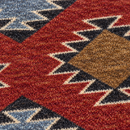 Crossplay area rug: close-up of a ttextured area rug with a Southwestern geometric pattern in red, brown, black, blue, and cream.
