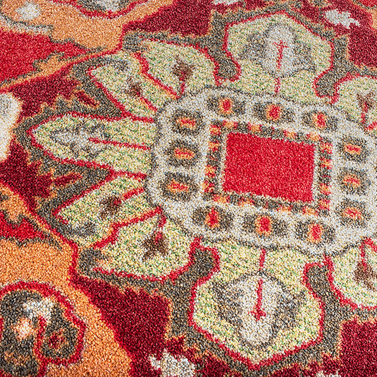 Firelight area rug: a close-up of a ttextured area rug with a traditional medallion pattern in red, orange, beige, and gray.
