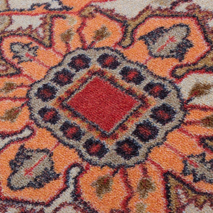 Hot Streak area rug: close-up of a patterned area rug with a central red diamond and surrounding orange, beige, and dark gray floral motifs.