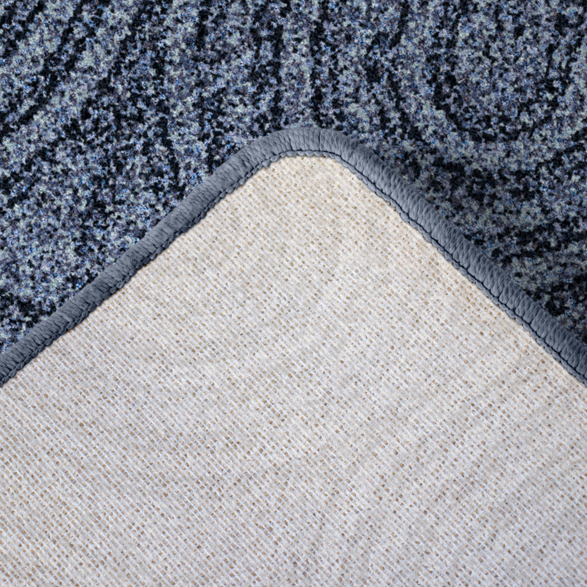 Joyride area rug with corner turned back to show backing