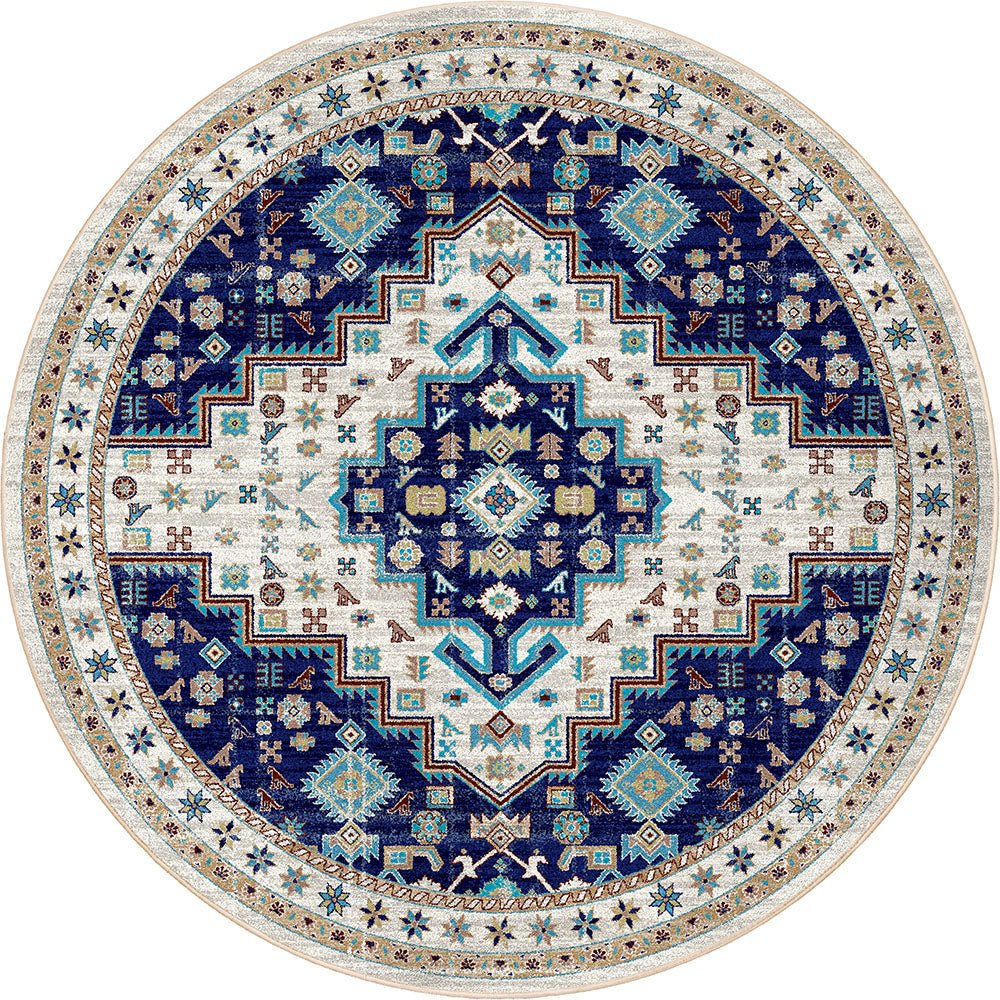 A round area rug with an intricate traditional geometric pattern in navy blue, cream, and turquoise, shown flat against a white background.