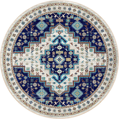 A round area rug with an intricate traditional geometric pattern in navy blue, cream, and turquoise, shown flat against a white background.