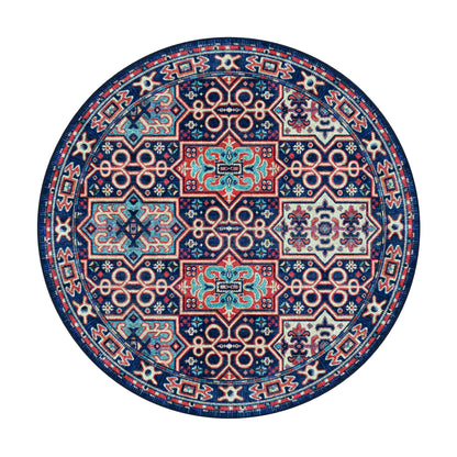 A round area rug with an intricate traditional geometric pattern in navy blue, red, light blue, and cream, shown from a top-down view on a solid white background.