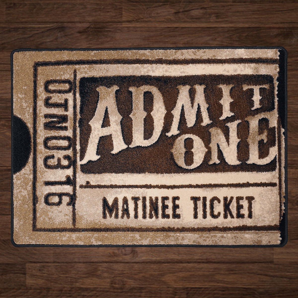 A rectangular mat designed to look like a vintage 'Admit One Matinee Ticket' with distressed beige and dark brown tones, placed on a dark wood floor.