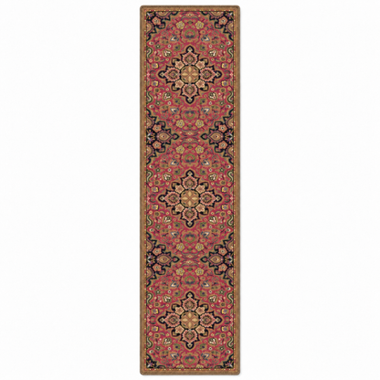 A long rectangular area rug with an ornate traditional medallion pattern in dusty pink, beige, black, and muted blue, shown flat against a plain white background.