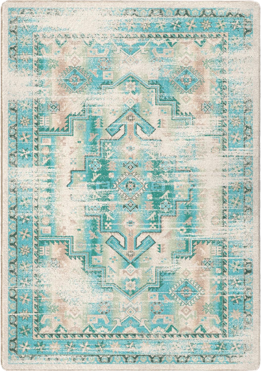 A rectangular area rug with a distressed geometric and medallion pattern in turquoise, teal, cream, and soft blush pink tones.