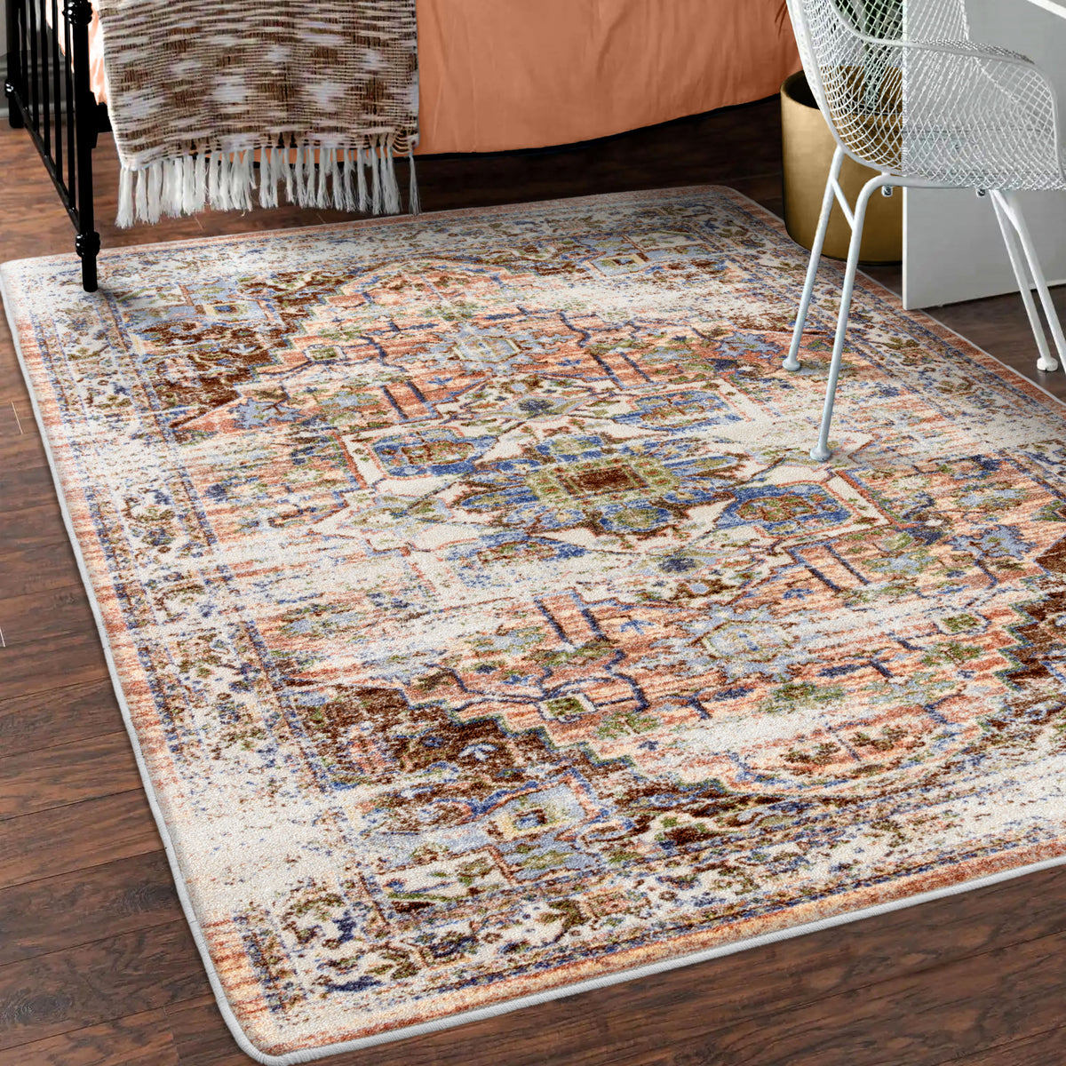 Patterned area rug on a wooden floor with furniture in the background