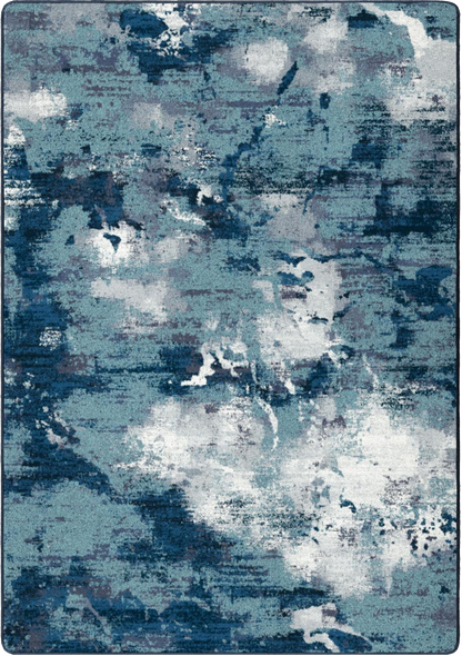 An abstract area rug featuring a distressed, watercolor-like pattern in shades of blue, slate gray, and white.